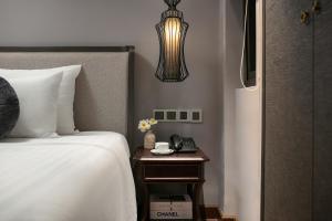 Ένα ή περισσότερα κρεβάτια σε δωμάτιο στο Hanoi L'Heritage Hotel & Gym - Spa