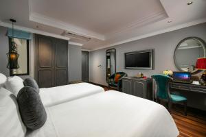 Ένα ή περισσότερα κρεβάτια σε δωμάτιο στο Hanoi L'Heritage Hotel & Gym - Spa