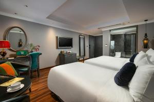 Ένα ή περισσότερα κρεβάτια σε δωμάτιο στο Hanoi L'Heritage Hotel & Gym - Spa