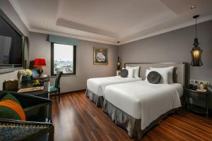Ένα ή περισσότερα κρεβάτια σε δωμάτιο στο Hanoi L'Heritage Hotel & Gym - Spa