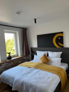 a bedroom with a large bed and a window at Hotel Am Markt in Besigheim