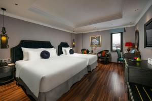 Ένα ή περισσότερα κρεβάτια σε δωμάτιο στο Hanoi L'Heritage Hotel & Gym - Spa