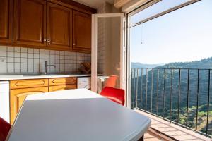a kitchen with a large window with a view of a balcony at Piso con vista espectacular en Vistabella in Vistabella del Maestrazgo