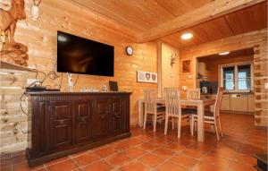 a dining room with a table and a flat screen tv at Awesome Home In Dalaas With 2 Bedrooms And Wifi in Dalaas