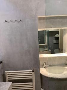 a bathroom with a sink and a mirror at Fillungo180 in Lucca
