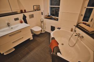 a bathroom with a tub and a sink and a toilet at Feriendomizil Villa Neidstein in Neukirchen bei Sulzbach-Rosenberg