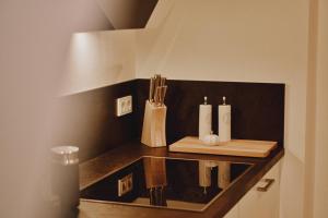 a counter with three white candles on a shelf at Feriendomizil Villa Neidstein in Neukirchen bei Sulzbach-Rosenberg