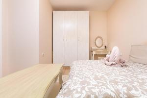 a bedroom with a bed with a pink stuffed animal on it at Bright & Cozy 1BD Flat with a Terrace and Parking in Plovdiv