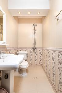a bathroom with a white toilet and a sink at Bright & Cozy 1BD Flat with a Terrace and Parking in Plovdiv
