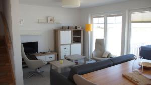 a living room with a blue couch and a television at Ostseeperle in Kappeln
