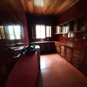 a kitchen with a bench in the middle of a room at Ocean View Guesthouse in São Tomé