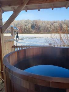 a hot tub on a deck with a view of a lake at La cabane au bain perché 