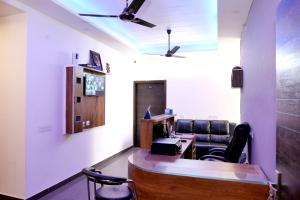 an office with a desk and chairs and a ceiling at HOTEL IRA Mansarovar Jaipur in Jaipur