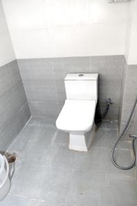 a bathroom with a white toilet in a stall at HOTEL IRA Mansarovar Jaipur in Jaipur
