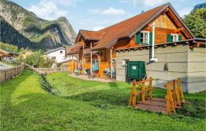 a house with a wooden fence next to a yard at Pet Friendly Home In Dalaas With Wifi in Dalaas