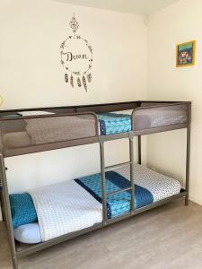 a bunk bed room with three bunk beds at Asteria in Ouistreham
