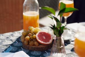 a plate of grapes and a grapefruit on a table at Hotel Lovran in Lovran