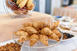 a bowl of food on a table with nuts at Hotel Lovran in Lovran