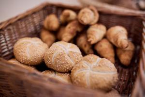 a basket filled with buns and breads at Hotel Lovran in Lovran