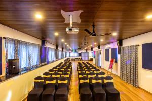 a conference room with a table and chairs in it at Ramee Wolkenburg Resort & Spa, Munnar in Munnar