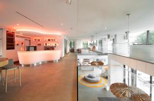 a large kitchen and living room with glass walls at EVOLUTION Lisboa Hotel in Lisbon