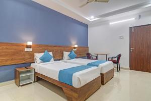 a bedroom with a large bed and a table at The Balcony Hotel in Hyderabad
