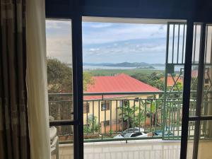 a view of a building from a window at Kim luxury apartment in Kampala