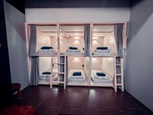 Bed Attitude Hostel Cenang في بانتايْ سينانج: غرفة بها أربعة أسرة بطابقين في غرفة