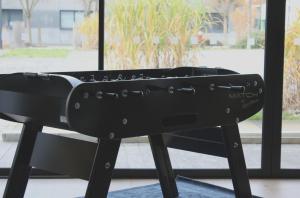 a black keyboard on a stand in front of a window at Campanile Laval Nord in Changé