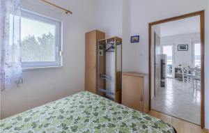 a bedroom with a bed and a window and a door at Nice Apartment In Pula With Kitchen in Medulin