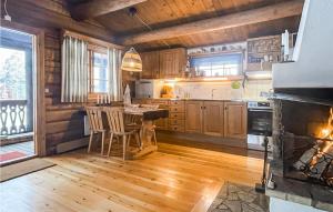 a kitchen with a stove and a table with chairs at Awesome Home In Sunne With Wifi in Sunne