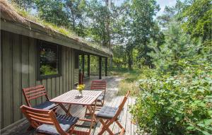 a wooden deck with a table and chairs on it at Awesome Home In Samsø With Kitchen in Nordby
