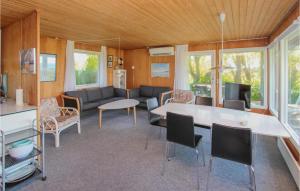 ein Wohnzimmer mit einem Sofa, einem Tisch und Stühlen in der Unterkunft Nice Home In Sams With Kitchen in Kolby Kås