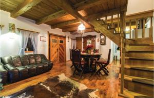a living room with a leather couch and a table at Nice Home In Klanjec With Sauna in Klanjec