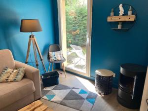 a living room with a couch and a window at Le Parc in Bergerac