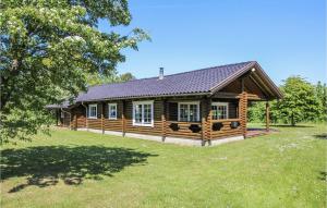 a log cabin with a large yard in front of it at 3 Bedroom Stunning Home In Sams in Onsbjerg