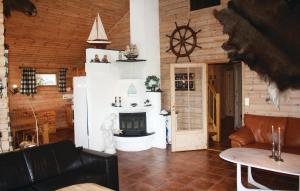 a living room with a fireplace in a cabin at Nice Home In Lindesnes With House Sea View in Svenevik