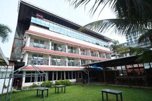 a building with two tables in front of it at AQUARIA THE BOUTIQUE RESORT in Cochin