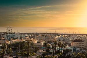 a city with a ferris wheel in the distance at Apartment Puerto Marina - First Line Beach - Benalmadena - Málaga in Benalmádena