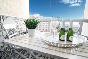 two bottles of wine on a table on a balcony at Apartment Puerto Marina - First Line Beach - Benalmadena - Málaga in Benalmádena