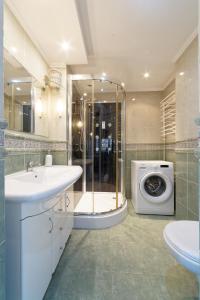 a bathroom with a sink and a washing machine at Old Town Kanonia Apartments in Warsaw