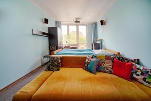 a bedroom with a bed and a large wooden floor at Old Town Kanonia Apartments in Warsaw