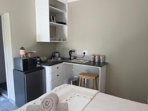 a small kitchen with a sink and a microwave at Guest house on Gillian Unit 5 in Ballito