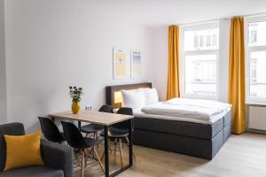 a bedroom with a bed and a table and chairs at Homaris Boxi Studios in Berlin
