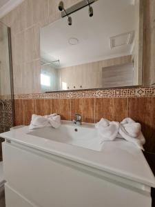 a bathroom with a white sink and a mirror at El Olivar La Vega de Tetir in Tetir