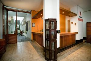 a corridor of a building with a counter and a room at Hotel Poncowinatan - Tugu in Yogyakarta