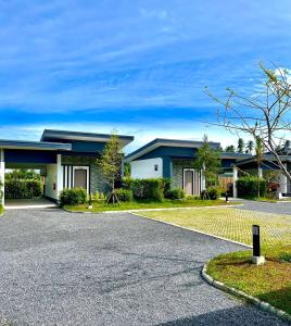 a house with a driveway in front of it at Blue Moon Boutique Resort in Sichon