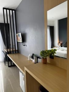a room with a desk with a bed in the background at Blue Moon Boutique Resort in Sichon +42 photos