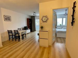a kitchen and dining room with a table and a bedroom at Town Center Chmielna 116/118 in Warsaw