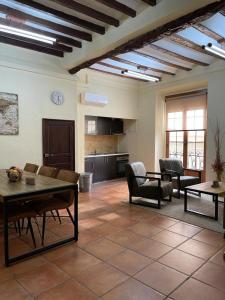 a living room with couches and a table and chairs at Casa Monovar in Monóvar